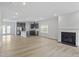 Spacious living area with a fireplace, hardwood floors, gray cabinets and stainless steel appliances in the kitchen at 9249 Kitchin Farms Way # 432, Wake Forest, NC 27587