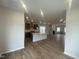 Open-concept floor plan featuring a fireplace, kitchen and dining area at 9249 Kitchin Farms Way # 432, Wake Forest, NC 27587