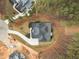 Aerial view of a home with a grey roof and ample yard space surrounded by trees at 7440 Summer Tanager Trl, Raleigh, NC 27614