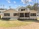 Lush green backyard with a screened porch on the rear exterior of this home at 7440 Summer Tanager Trl, Raleigh, NC 27614