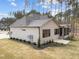 Rear exterior view of home featuring a screened porch and lush landscaping at 7440 Summer Tanager Trl, Raleigh, NC 27614