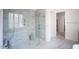 Spa-like bathroom with marble shower and soaking tub at 7440 Summer Tanager Trl, Raleigh, NC 27614