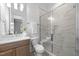 Bathroom with a double sink vanity and a glass-enclosed shower at 7440 Summer Tanager Trl, Raleigh, NC 27614