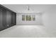 Spacious bedroom with carpet and a wall of windows offering an outdoor view at 7440 Summer Tanager Trl, Raleigh, NC 27614