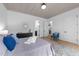 Relaxing bedroom featuring tray ceiling, stylish decor, and access to ensuite bathroom at 7440 Summer Tanager Trl, Raleigh, NC 27614