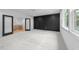 Bedroom featuring black accent wall and access to the hallway through glass doors at 7440 Summer Tanager Trl, Raleigh, NC 27614