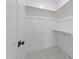 Walk-in closet with carpet and open wood shelving at 7440 Summer Tanager Trl, Raleigh, NC 27614