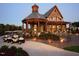 Stunning stone clubhouse with outdoor seating and beautifully landscaped entrance at 7440 Summer Tanager Trl, Raleigh, NC 27614