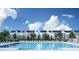Refreshing community pool with lounge chairs, surrounded by well-maintained townhomes at 7440 Summer Tanager Trl, Raleigh, NC 27614