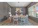 The dining room features wainscotting, a decorative light fixture, and a large window at 7440 Summer Tanager Trl, Raleigh, NC 27614