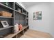 This entryway features custom shelving, a bench, pillows and unique decor at 7440 Summer Tanager Trl, Raleigh, NC 27614