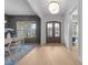 The entryway showcases light wood floors, a decorative chandelier, and a view into the dining room at 7440 Summer Tanager Trl, Raleigh, NC 27614