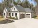 The house features a two-car garage and manicured landscaping at 7440 Summer Tanager Trl, Raleigh, NC 27614