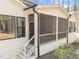Screened in porch on the back of an off white home with black trimmed windows at 7440 Summer Tanager Trl, Raleigh, NC 27614