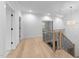 Bright hallway with hardwood floors and wrought iron staircase at 7440 Summer Tanager Trl, Raleigh, NC 27614