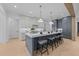 An elegant kitchen features a large center island with barstool seating at 7440 Summer Tanager Trl, Raleigh, NC 27614