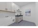 This laundry room features sleek cabinets, a utility sink, and modern fixtures at 7440 Summer Tanager Trl, Raleigh, NC 27614