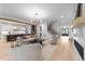 Open concept living area with hardwood floors, fireplace, staircase, and lots of seating at 7440 Summer Tanager Trl, Raleigh, NC 27614