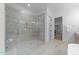 Bright main bathroom showcasing a glass-enclosed shower with marble surround, and neutral color palette at 7440 Summer Tanager Trl, Raleigh, NC 27614