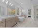 Bright main bathroom features dual vanities, soaking tub, and walk-in shower at 7440 Summer Tanager Trl, Raleigh, NC 27614