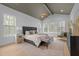 Bright main bedroom with vaulted ceilings, recessed lighting, and serene outdoor views at 7440 Summer Tanager Trl, Raleigh, NC 27614