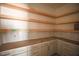 Open shelving pantry with white tile backsplash at 7440 Summer Tanager Trl, Raleigh, NC 27614