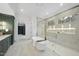 Spa-like bathroom with soaking tub, walk-in shower, and marble flooring at 7645 Falls Creek Ln, Raleigh, NC 27614