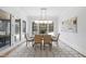 Bright dining room features a wooden table, neutral chairs, and a geometric rug at 7645 Falls Creek Ln, Raleigh, NC 27614