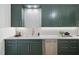 Modern kitchen with sleek dark green cabinets and a quartz countertop at 7645 Falls Creek Ln, Raleigh, NC 27614