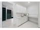 Well-appointed laundry room with white cabinets and ample counter space at 7645 Falls Creek Ln, Raleigh, NC 27614