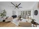 Spacious living room with hardwood floors and large windows at 7645 Falls Creek Ln, Raleigh, NC 27614