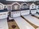 An aerial view shows the townhome exteriors, including the garages and driveways at 187 Pinkie Ln, Garner, NC 27529