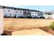 View of the newly constructed backyard of a townhome with a graded lawn ready for landscaping at 187 Pinkie Ln, Garner, NC 27529