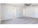 Spacious bedroom with ceiling fan, carpet, and adjacent walk-in closet at 187 Pinkie Ln, Garner, NC 27529