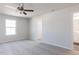 Bright and airy bedroom with ceiling fan, closet, and ensuite bathroom at 187 Pinkie Ln, Garner, NC 27529