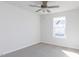 Well-lit bedroom with a ceiling fan, neutral carpet, and a window providing natural light at 187 Pinkie Ln, Garner, NC 27529