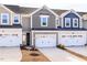 Townhome exteriors feature a one-car garage and a neutral color scheme at 187 Pinkie Ln, Garner, NC 27529