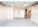 Spacious two car garage with concrete floor and attached water heater at 187 Pinkie Ln, Garner, NC 27529