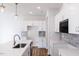Bright kitchen with white cabinets, a gray backsplash, an island with a sink, and stainless steel appliances at 187 Pinkie Ln, Garner, NC 27529