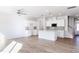 Open concept kitchen and living space featuring new wood floors, white cabinets, and stainless steel appliances at 187 Pinkie Ln, Garner, NC 27529