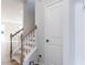 Carpeted staircase with white wood banister and natural oak handrail at 187 Pinkie Ln, Garner, NC 27529