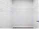 Walk-in closet with shelving, hanging rods, and carpet flooring at 187 Pinkie Ln, Garner, NC 27529