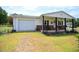 Lovely home with an attached garage and inviting front porch perfect for relaxing at 101 Mulberry Ln, Dunn, NC 28334