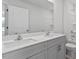 Bathroom featuring double sink vanity, white countertop, and an oversized mirror at 543 Old Battle Bridge Rd, Wendell, NC 27591