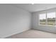 Bright bedroom showcasing a large window with outdoor views and neutral walls at 543 Old Battle Bridge Rd, Wendell, NC 27591