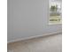 Bright bedroom showcasing a large window with green outdoor views and neutral walls at 543 Old Battle Bridge Rd, Wendell, NC 27591