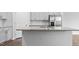 Close-up of a kitchen island with a granite countertop and stainless steel sink at 543 Old Battle Bridge Rd, Wendell, NC 27591