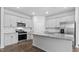 Modern kitchen with white cabinets, stainless steel appliances, and granite countertops at 543 Old Battle Bridge Rd, Wendell, NC 27591