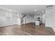 Open-concept living space with hardwood floors, stairs, and kitchen view at 543 Old Battle Bridge Rd, Wendell, NC 27591