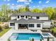 An aerial view showcasing the pool, patio, and landscaping of the modern home at 861 Wimbleton Dr, Raleigh, NC 27609